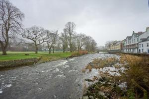 a river in a town with houses and buildings at Riverside Park 1 in Keswick