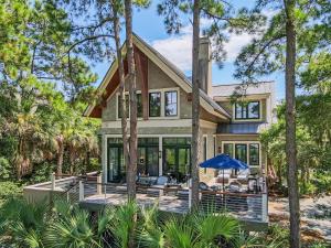 a house with a wrap around porch with trees at 119 Halona Ln in Kiawah Island