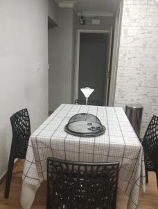 a dining room table with a plate on top of it at Casa Magalhães Hospedaria in Extrema +4 photos