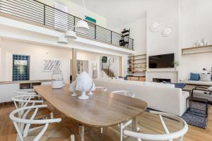 a dining room and living room with a table and chairs at 217 Glen Abbey in Kiawah Island