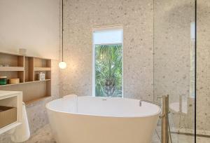 a white bath tub in a bathroom with a window at 217 Glen Abbey in Kiawah Island +53 photos