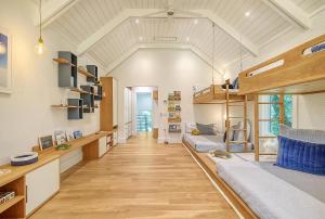 a living room with a loft bed and wooden floors at 217 Glen Abbey in Kiawah Island