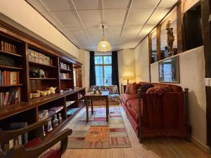 a living room with a couch and a table at Our Hippie Castle Vianden - Unique Bohemian Guesthouse in Vianden