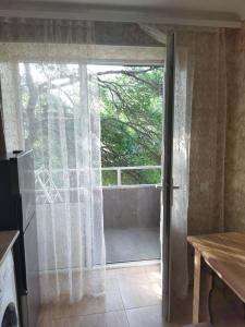 a kitchen with a sliding glass door with a window at Vadamar Apartment in Sisian