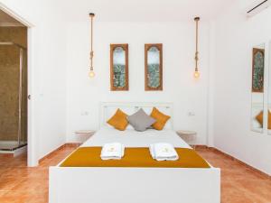 a bedroom with a bed with two towels on it at Paço no Monte by Stay ici in Montargil +58 photos