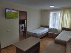 a living room with two beds and a couch at Vadamar Apartment in Sisian