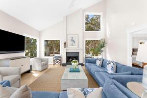 a living room with blue couches and a tv at 2455 The Bent Twig in Seabrook Island