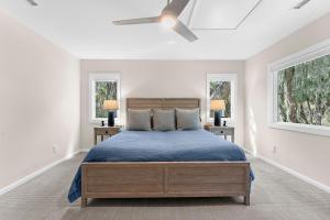 a white bedroom with a bed and two windows at 2455 The Bent Twig in Seabrook Island +75 photos