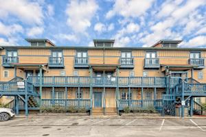 an apartment building with blue balconies and a parking lot at Alpine Retreat in Helen