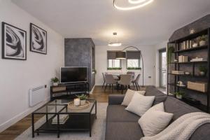a living room with a couch and a tv at Dixon's Yard, City Centre - Free Parking in York