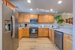 a kitchen with wooden cabinets and stainless steel appliances at Alpine Retreat in Helen