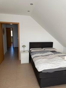 a bedroom with a bed and a night stand at Ferienwohnung in Staufenberg- Treis in Staufenberg