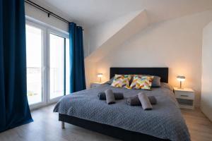 a bedroom with a large bed with two pillows at Modern 2023 apartment in Kutno