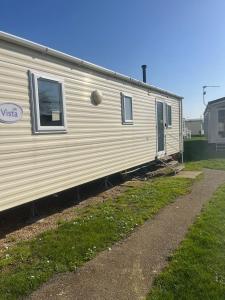 a mobile home is parked in a yard at 159 Summerfields in Great Yarmouth