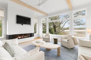 a living room with white furniture and a fireplace at 117 Halona in Kiawah Island