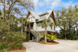 a house with a palm tree in front of it at 117 Halona in Kiawah Island