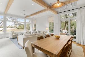 a living room with a wooden table and chairs at 117 Halona in Kiawah Island