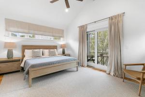 a bedroom with a bed and a large window at 117 Halona in Kiawah Island