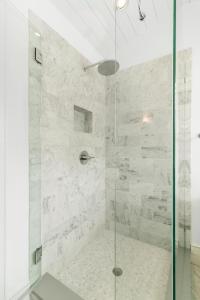 a bathroom with a shower with a glass door at 117 Halona in Kiawah Island +52 photos