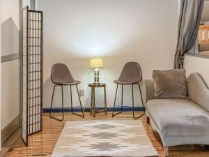 a living room with two chairs and a couch at Loft 40 in Cleveland