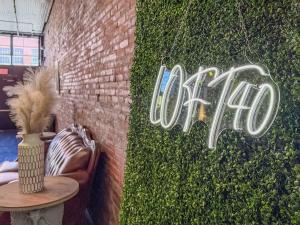 a ivy covered wall with a sign that reads cafe at Loft 40 in Cleveland