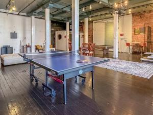 a ping pong table in the middle of a room at Loft 40 in Cleveland +38 photos