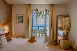a bedroom with a bed with a view of the ocean at Best Western Premier Hotel Prince de Galles in Menton