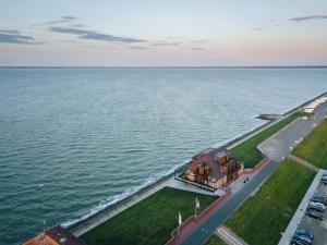an aerial view of a house by the water at Fliegerdeich Hotel & Restaurant in Wilhelmshaven