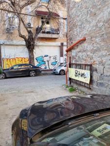 a car parked in front of a building with graffiti at GuestHouse 4 Karma369 in Plovdiv