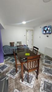a living room with a table and a couch at Departamento Independiente a 2 cuadras de Costanera in Punta Arenas