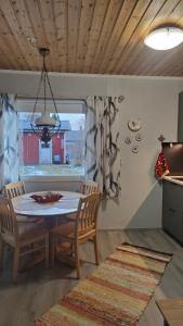 a dining room with a table and chairs at Mumrila in Pori +18 photos