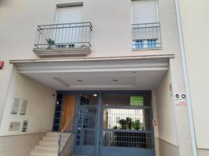 a building with a door and stairs in front of it at Atelier de lujo lucena in Lucena