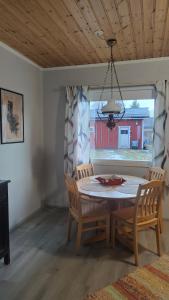 a dining room with a table and chairs and a window at Mumrila in Pori
