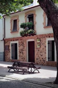 a bench sitting in front of a building at Patio de las Flores in Riópar