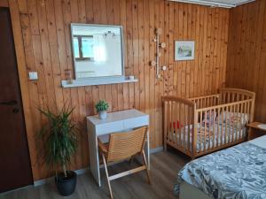 a bedroom with a bed and a table and a mirror at Prenočišče Breza in Radovljica