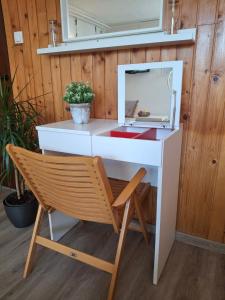 a white desk with a chair and a microwave at Prenočišče Breza in Radovljica +22 photos