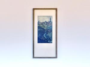 a framed picture of a city on a wall at Sonnenhof Seeg 08 in Seeg