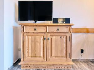 a wooden cabinet with a television on top of it at Sonnenhof Seeg 08 in Seeg +27 photos