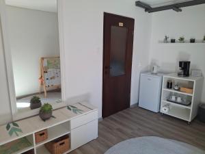 a living room with a door and a refrigerator at Prenočišče Breza in Radovljica