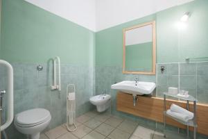 a bathroom with a sink and a toilet and a mirror at Sole d'Estate Agriresidence in Costa Rei +66 photos