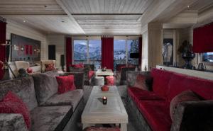 a large living room with couches and a table at Hotel Le K2 Altitude in Courchevel