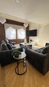 a living room with two couches and a table at Dock View Lodge in Liverpool