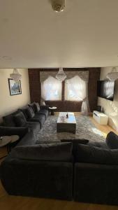 a living room with couches and a coffee table at Dock View Lodge in Liverpool