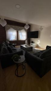 a living room with a couch and a table at Dock View Lodge in Liverpool +8 photos