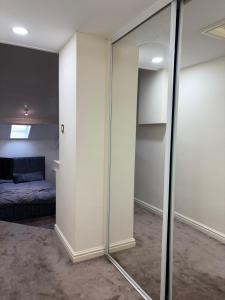 a room with sliding glass doors and a bed at Dock View Lodge in Liverpool