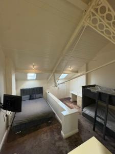 a room with a bed and a desk in it at Dock View Lodge in Liverpool