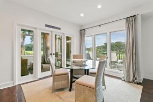 a dining room with a glass table and chairs at 4956 Green Dolphin in Kiawah Island