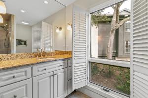 a bathroom with a sink and a large window at 4956 Green Dolphin in Kiawah Island +41 photos