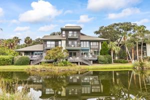 a large house with a pond in front of it at 4956 Green Dolphin in Kiawah Island