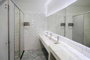 a bathroom with a sink and a mirror at Cacha Bed in Bangkok +43 photos